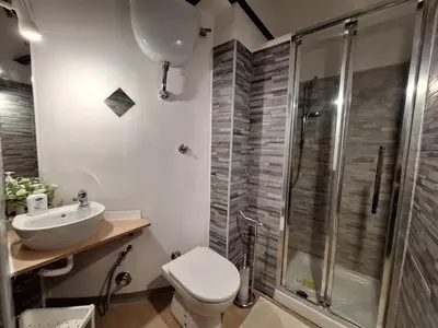 a bathroom with a toilet and a sink and a shower at Pensiero Romano in Rome