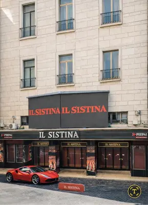 a red car parked in front of a building at RomAntic Dreams Sistina Guest House in Rome