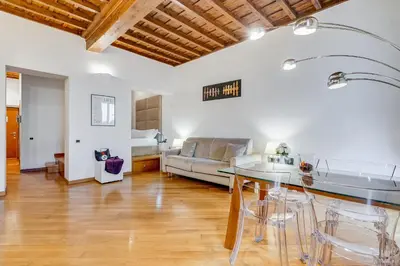 a living room with a couch and a table at Barberini Exclusive Loft in Rome