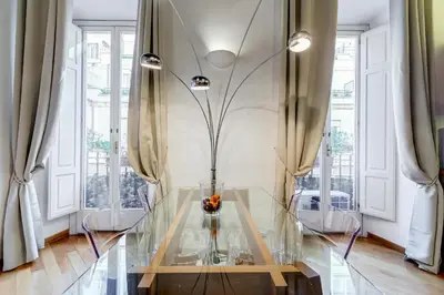 a glass table in a room with windows at Barberini Exclusive Loft in Rome