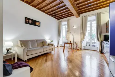 a living room with a couch and a table at Barberini Exclusive Loft in Rome