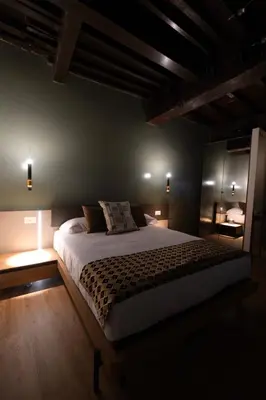 a bedroom with a large bed in a dark room at Casa Orchidea in Rome