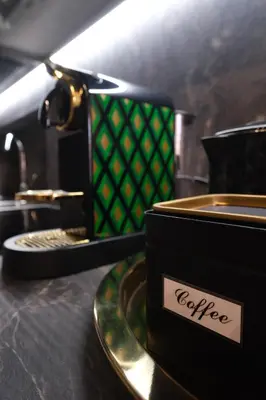a black box on a plate next to a coffee machine at Casa Orchidea in Rome