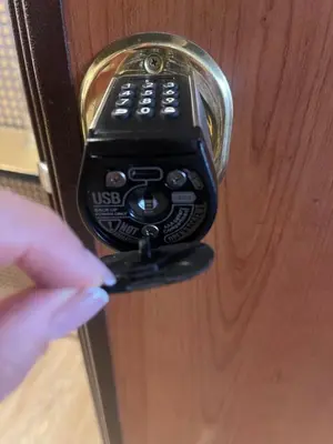 a person unlocking a door with a remote control at Casa Orchidea in Rome