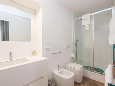 a white bathroom with a sink and a toilet at Sistina 143 A-B-C in Rome