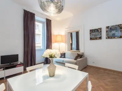 a living room with a vase of flowers on a table at Sistina 143 A-B-C in Rome