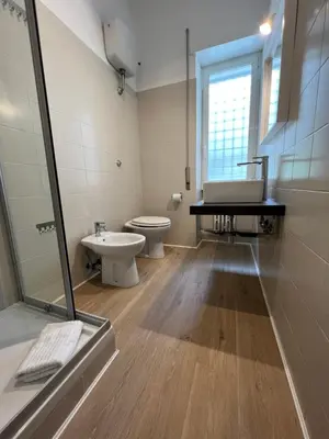a bathroom with a toilet and a sink and a shower at Appartamento Millelire in Rome