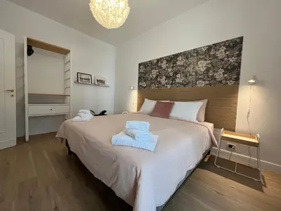 a bedroom with a large bed with two towels on it at Appartamento Millelire in Rome