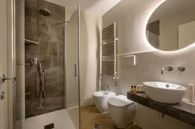 a bathroom with a sink and a toilet and a shower at Porta Castello Suites in Rome