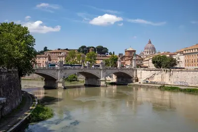 a bridge over a river in a city at Porta Castello Suites in Rome