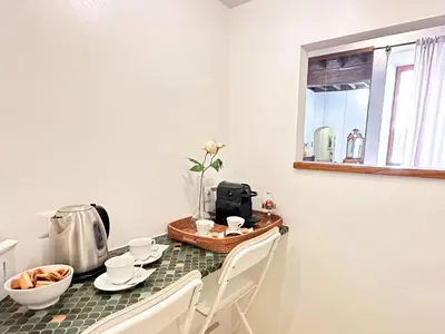 a kitchen with a table with a coffee maker and a tea kettle at Casa Lovera in Vaticano in Rome
