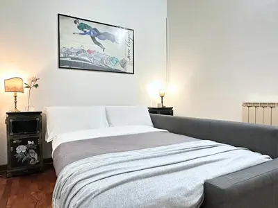 a bedroom with a bed and a picture on the wall at Casa Lovera in Vaticano in Rome