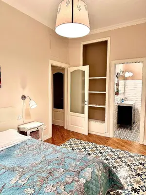 a bedroom with a bed and a lamp at Luxury Apartment by Palazzo Senesi in Rome