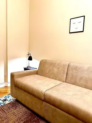 a brown couch sitting in a living room at Luxury Apartment by Palazzo Senesi in Rome