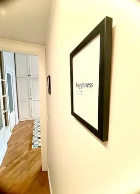 a picture frame hanging on a wall in a hallway at Luxury Apartment by Palazzo Senesi in Rome