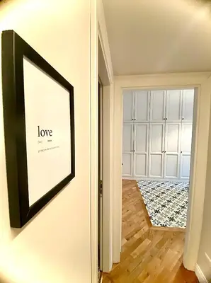a framed picture on a wall next to a door at Luxury Apartment by Palazzo Senesi in Rome