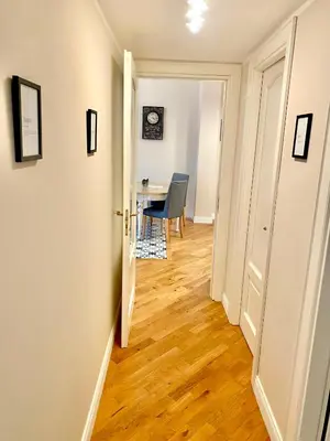 a hallway with a room with a table and a door at Luxury Apartment by Palazzo Senesi in Rome
