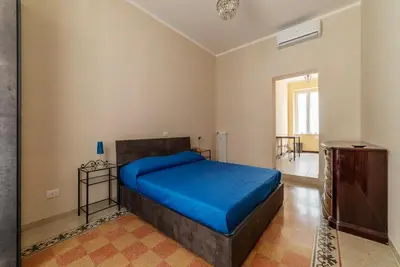 a bedroom with a bed with a blue blanket at GuestHost - Functional Apartment Piazza Re di Roma in Rome