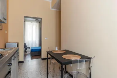 a kitchen with a table with two chairs in it at GuestHost - Functional Apartment Piazza Re di Roma in Rome