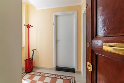 a hallway with a door and a red shovel at GuestHost - Functional Apartment Piazza Re di Roma in Rome