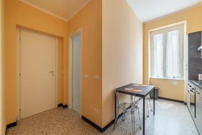 a room with a table and a window and a door at GuestHost - Functional Apartment Piazza Re di Roma in Rome