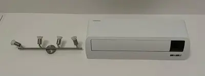 a microwave with four utensils on a wall at Appia Suite in Rome