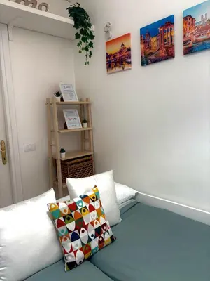 a bedroom with a bed and some pictures on the wall at Appia Suite in Rome