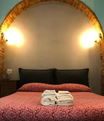 a bed with two folded towels on top of it at Termini GHome in Rome