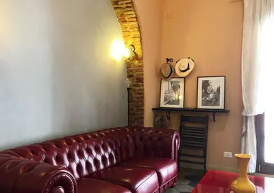 a leather couch in a living room with a fireplace at Termini GHome in Rome