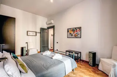 a bedroom with a bed and a couch in it at Domus Lunae in Rome