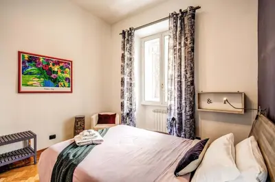 a bedroom with a bed and a window at Domus Lunae in Rome