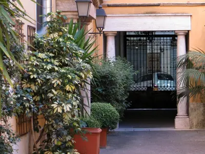 an entrance to a building with a gate and plants at Domus Lunae in Rome