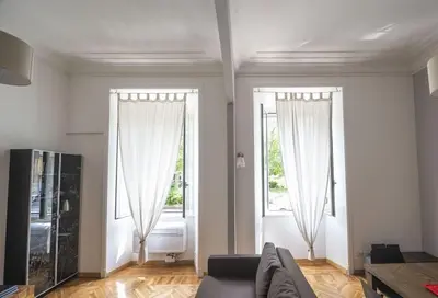 a living room with two windows and a couch at Lovely and new apartment near Termini Station in Rome
