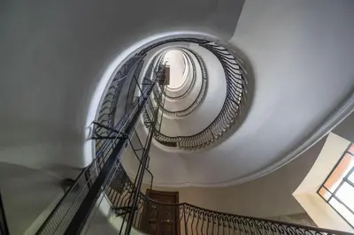 a spiral staircase in a building with a round window at Lovely and new apartment near Termini Station in Rome