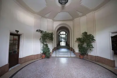 an empty hallway with potted plants in a building at Lovely and new apartment near Termini Station in Rome
