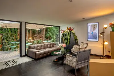 a living room with a leather couch and chairs at Fragrance Hotel St. Peter in Rome
