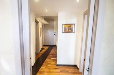 a hallway with white walls and a wooden floor at Testaccio Luminous and Large Apartment in Rome
