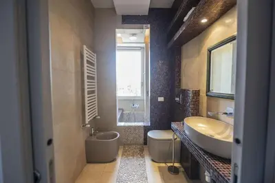 a bathroom with a tub and a sink and a tub at Testaccio Luminous and Large Apartment in Rome