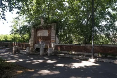 a stone monument in the middle of a street at Testaccio Luminous and Large Apartment in Rome