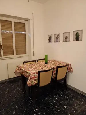 a dining room table with chairs and a table cloth at Romamor 2 in Rome