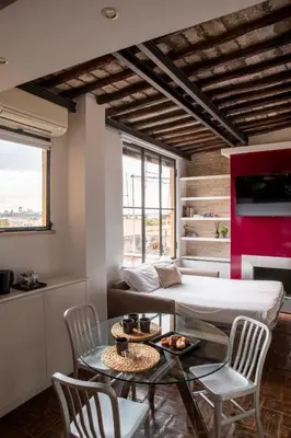 a bedroom with a bed and a table and chairs at Monti apartment BDB in Rome