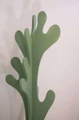a green metal tree on a white background at Casa Bouganville - St. Peter Romantic Apartment in Rome