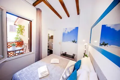 a bedroom with a bed and a large window at Collection Spanish Steps Apartments in Rome