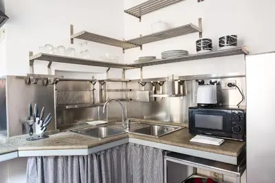 a kitchen with a sink and a microwave at Collection Spanish Steps Apartments in Rome