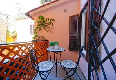 a small table and two chairs on a balcony at Collection Spanish Steps Apartments in Rome
