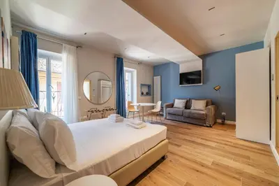 a bedroom with a bed and a living room at Luxury Corso Suite - DesignD Stays in Rome