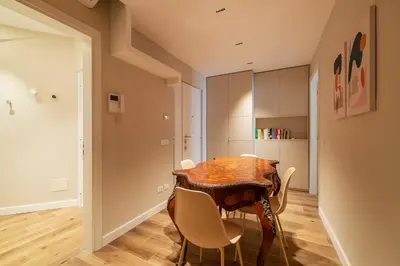 a dining room with a table and chairs at Luxury Corso Suite - DesignD Stays in Rome