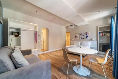 a living room with a couch and a table at Luxury Corso Suite - DesignD Stays in Rome