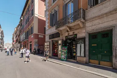 a group of people walking down a street at Luxury Corso Suite - DesignD Stays in Rome