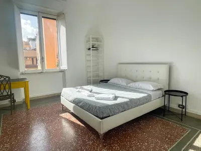 a bedroom with a bed with two pillows and a window at Angelico Boutique Apartment in Rome